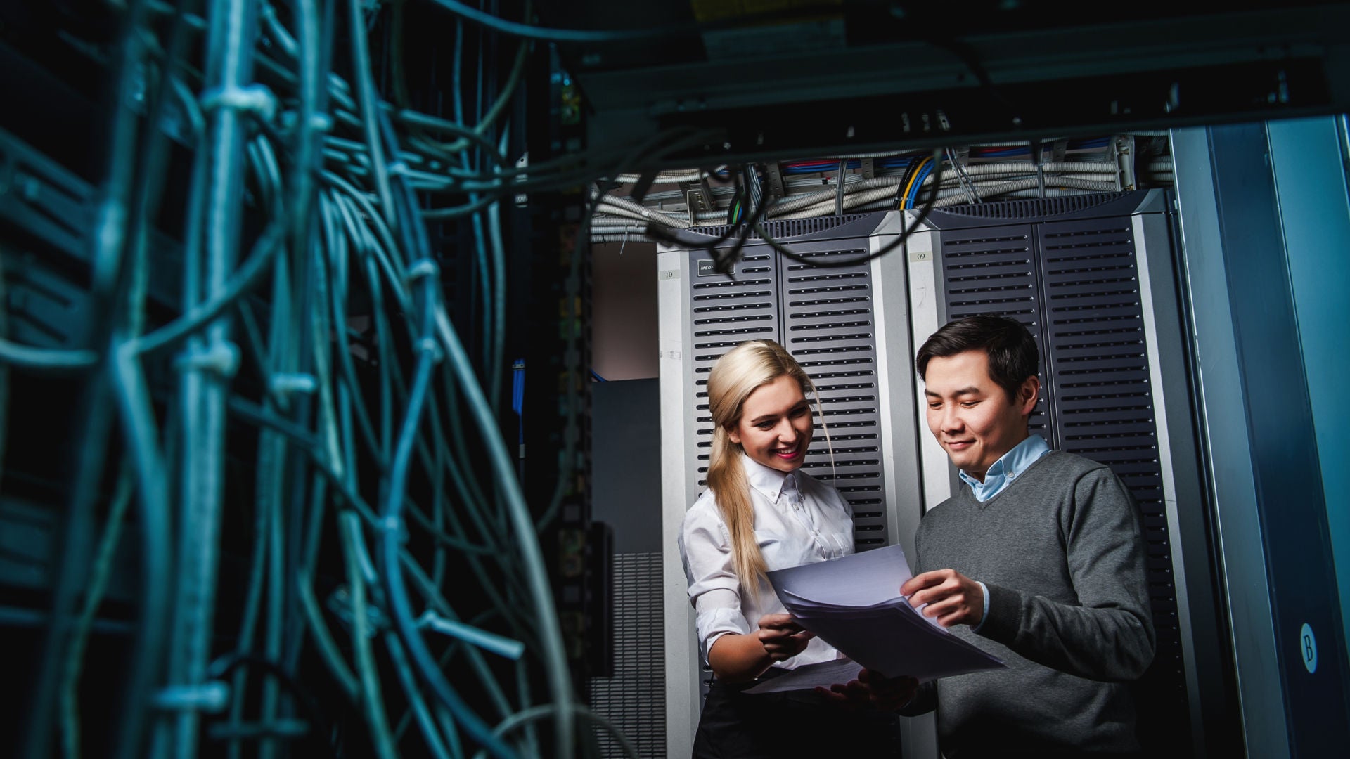 Young engineers businessmen in network server room