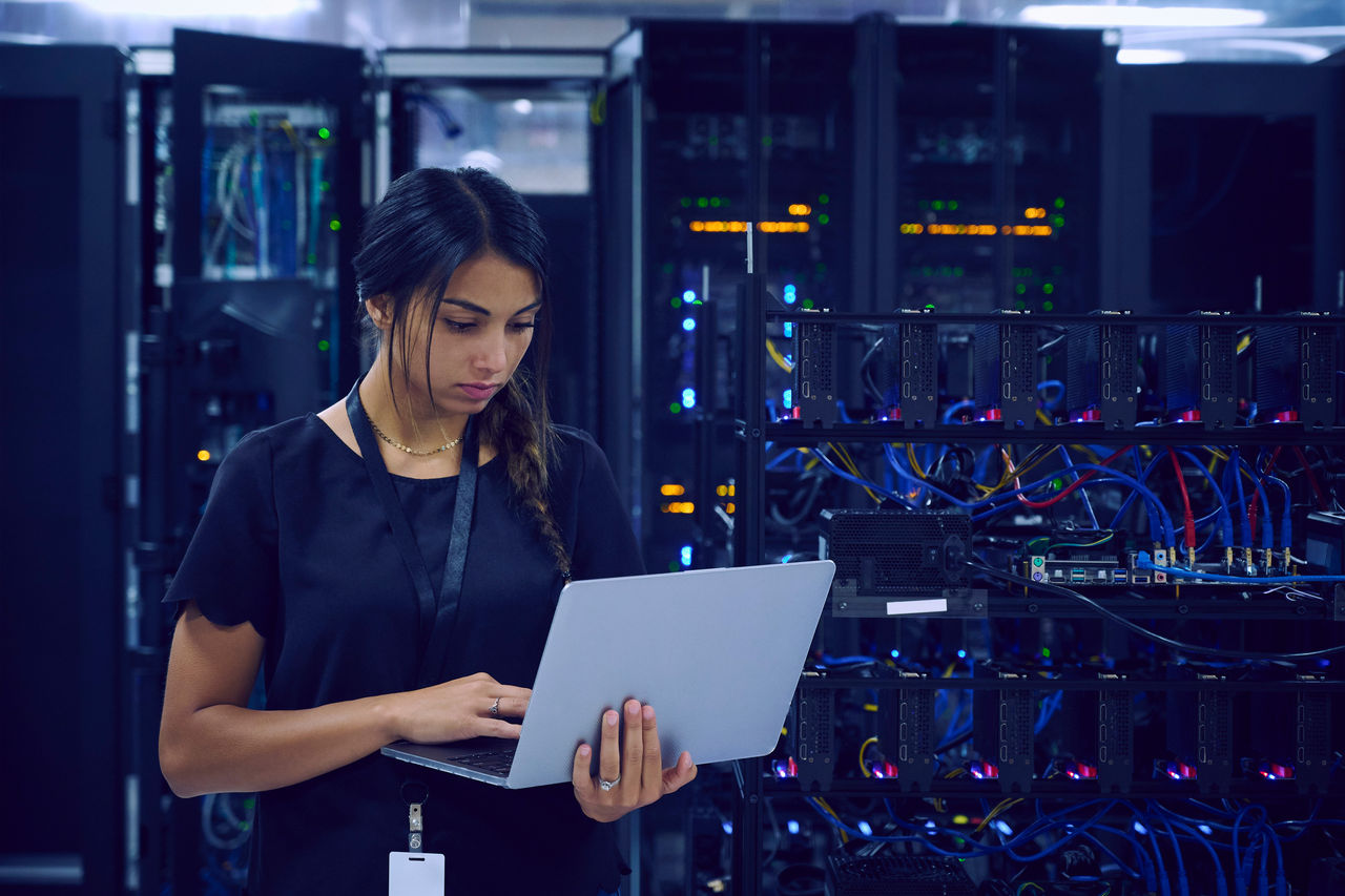 Woman checking network connection in a data center.