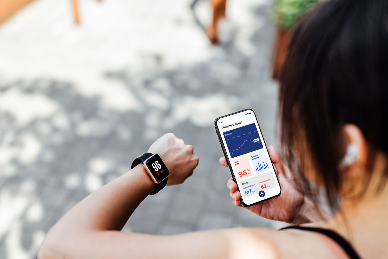 Person exercising checking their phone and their smart watch.