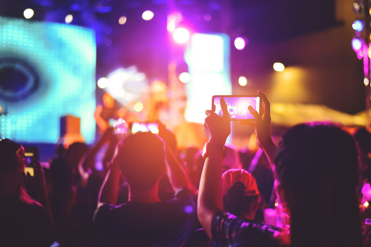 People at a concert recording on their phone.