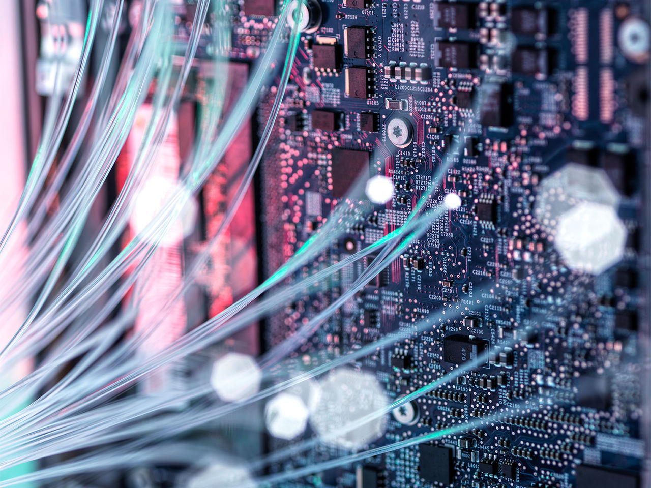 Fiber optic cables against computer mother board. 