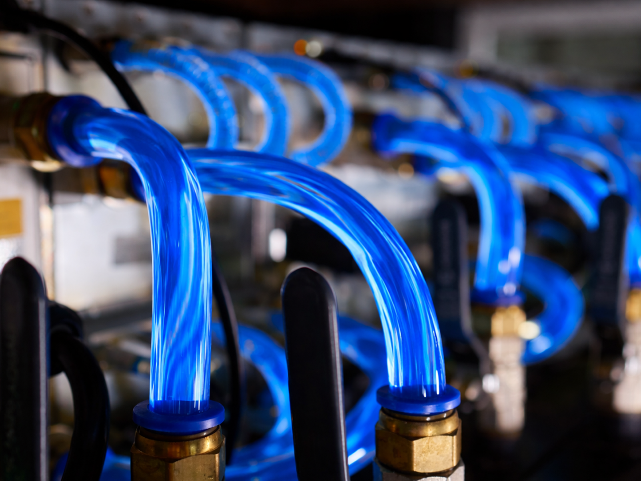 Close-up of a liquid cooling system in a data center, showing coolant tubes and heat sinks designed for high-performance thermal management.