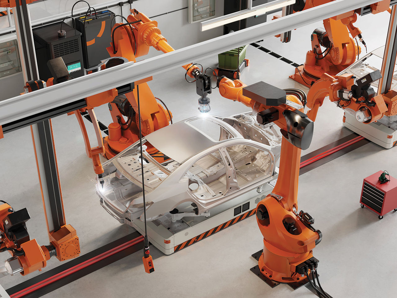 Robotic arms work around a car body frame in an automated industrial manufacturing cell.