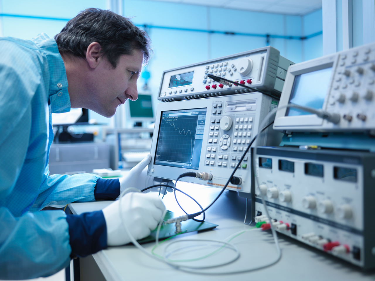 Engineer working with vector network analyzer equipment.