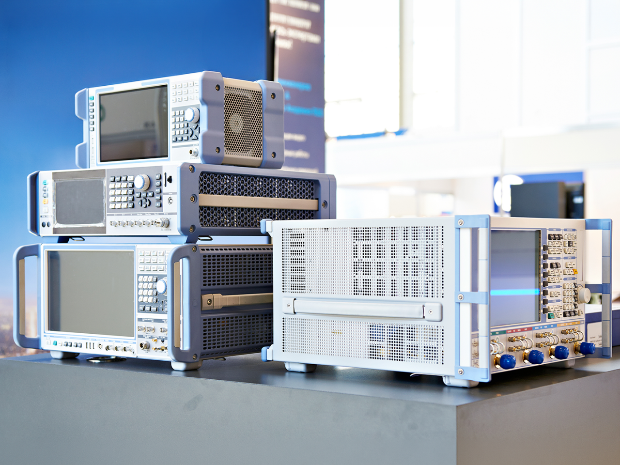 An engineer uses RF test and measurement equipment to analyze signal performance on a circuit board in a laboratory environment. 