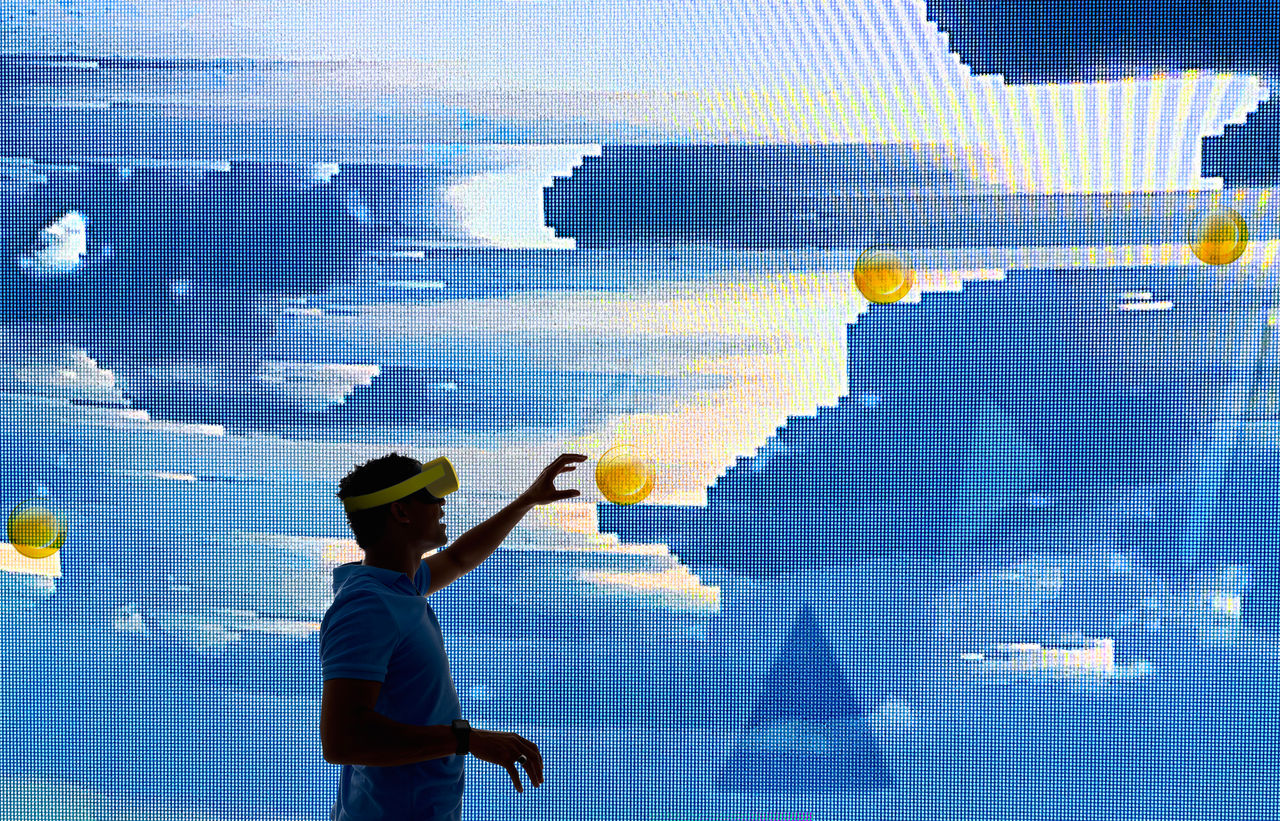 A young engineer uses virtual reality to interact with a innovative screen.