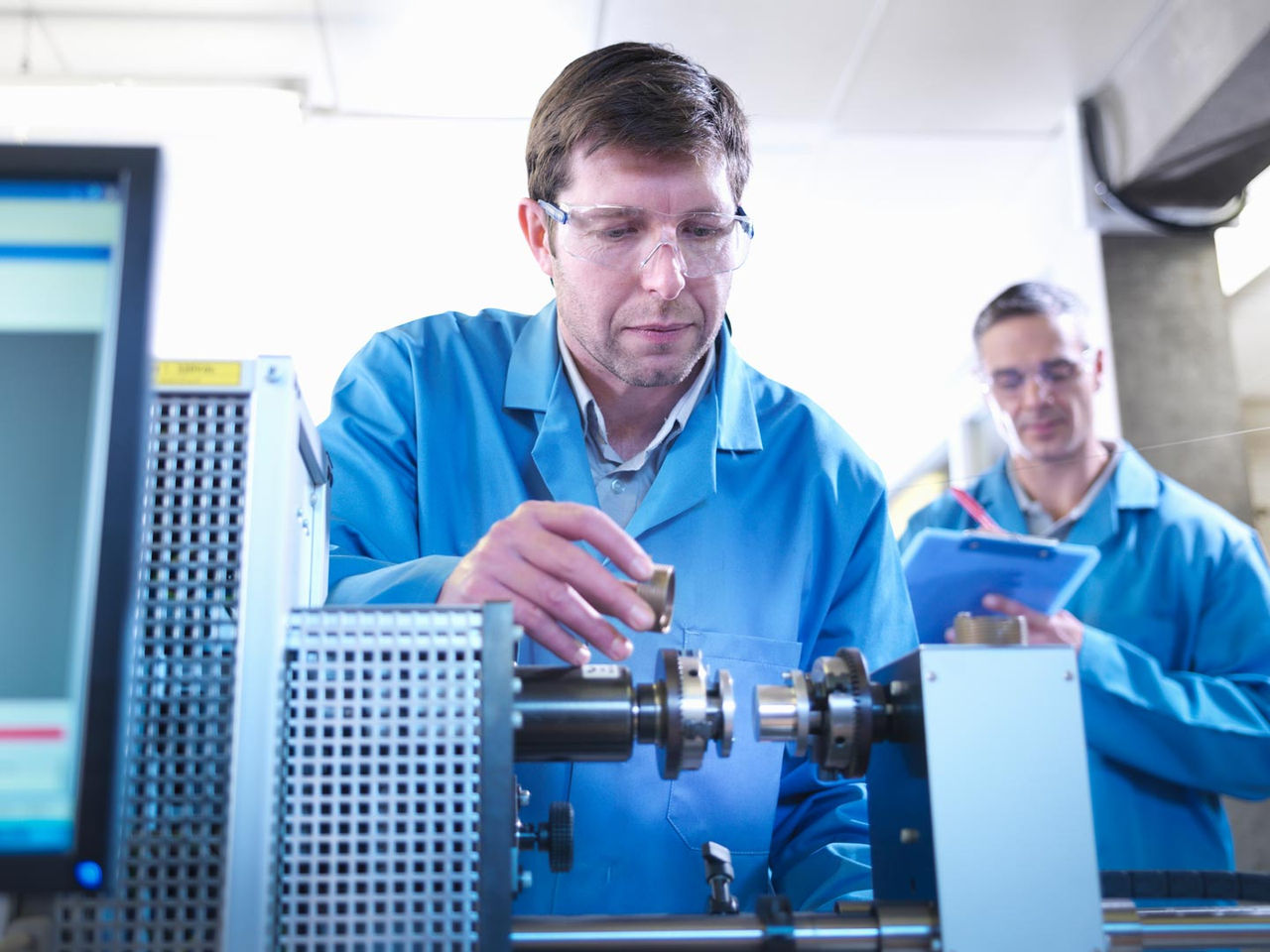 Engineers conduct accelerated reliability testing on a connector in a laboratory setting.
