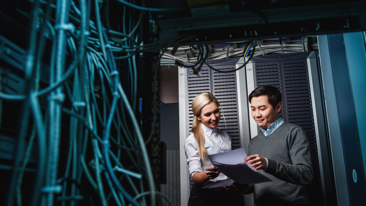 Young engineers businessmen in network server room